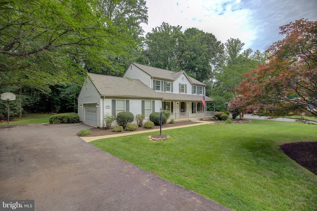9708 S Park Cir, Fairfax Station, VA 22039 - view of front facade featuring covered porch, an attached garage, a front lawn, asphalt driveway, and roof with shingles