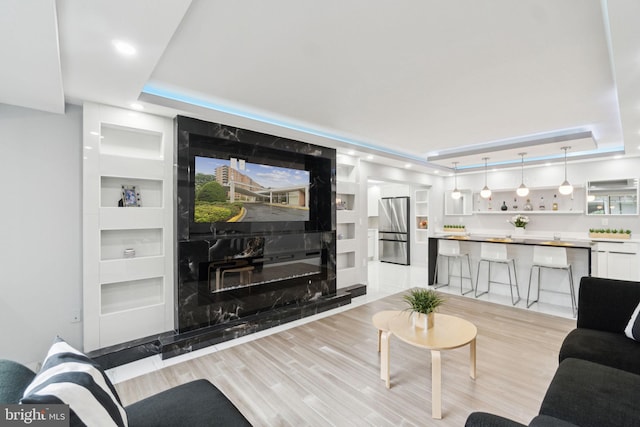 4201 Cathedral Ave NW Unit 122E, Washington, DC 20016 - living room featuring a raised ceiling, light wood-style floors, and recessed lighting