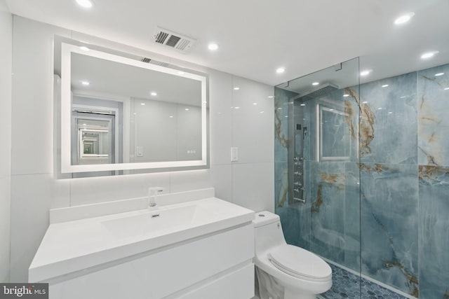 4201 Cathedral Ave NW Unit 122E, Washington, DC 20016 - bathroom featuring a marble finish shower, vanity, and recessed lighting