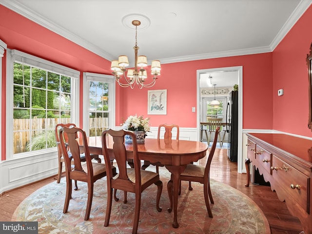 10267 Cedar Ridge Dr, Manassas, VA 20110 - dining area with a chandelier, healthy amount of natural light, crown molding, wainscoting, and wood finished floors