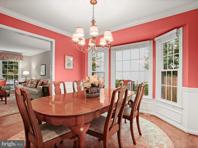 10267 Cedar Ridge Dr, Manassas, VA 20110 - dining room with crown molding, a chandelier, light wood-type flooring, and a wainscoted wall