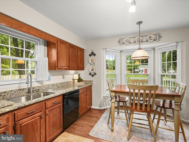 10267 Cedar Ridge Dr, Manassas, VA 20110 - kitchen with black dishwasher, healthy amount of natural light, light wood finished floors, and light stone counters