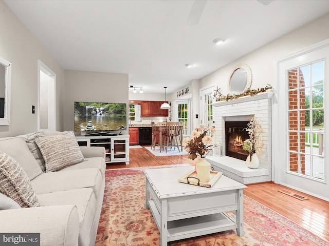 10267 Cedar Ridge Dr, Manassas, VA 20110 - living area with light wood-style floors and a brick fireplace