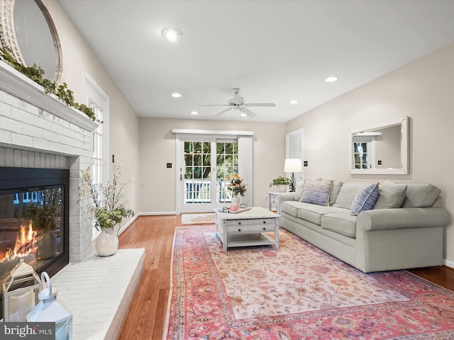 10267 Cedar Ridge Dr, Manassas, VA 20110 - living area featuring a brick fireplace, ceiling fan, light wood-style flooring, and recessed lighting