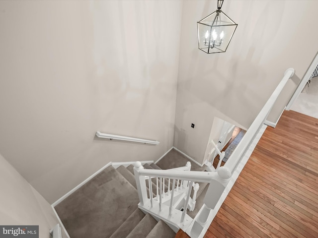 10267 Cedar Ridge Dr, Manassas, VA 20110 - staircase featuring a chandelier and wood-type flooring
