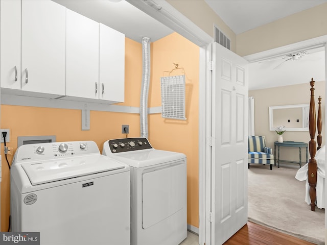 10267 Cedar Ridge Dr, Manassas, VA 20110 - laundry area featuring cabinet space, separate washer and dryer, and light wood-style floors