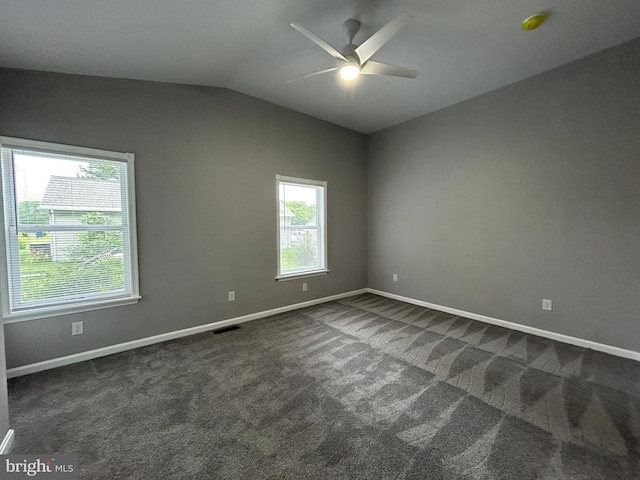 36697 W Club House Rd, Ocean View, DE 19970 - empty room featuring dark carpet, vaulted ceiling, a ceiling fan, and a smoke detector