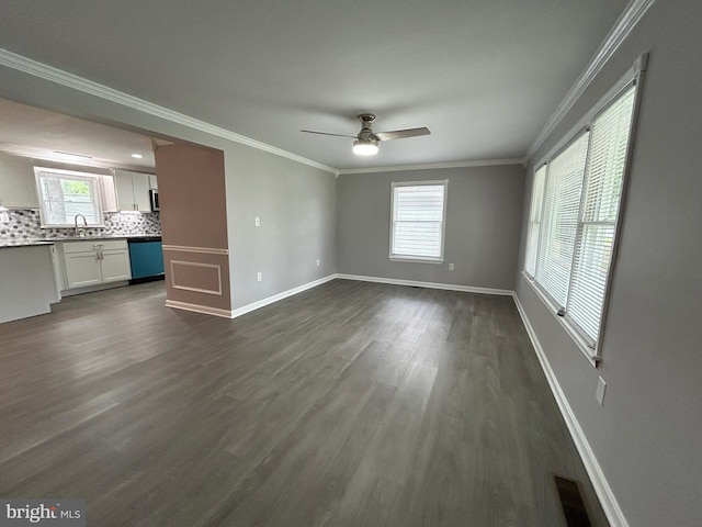 36697 W Club House Rd, Ocean View, DE 19970 - unfurnished living room featuring dark wood-style flooring, plenty of natural light, ceiling fan, and crown molding