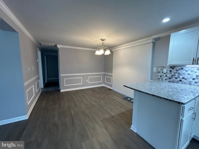 36697 W Club House Rd, Ocean View, DE 19970 - unfurnished dining area featuring a chandelier, a decorative wall, ornamental molding, dark wood-type flooring, and a wainscoted wall