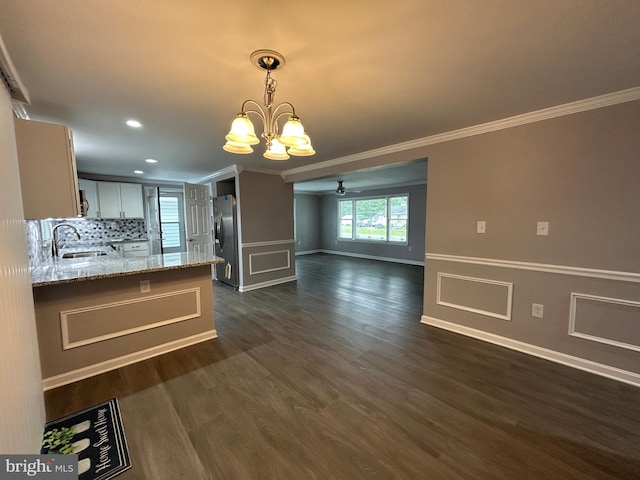 36697 W Club House Rd, Ocean View, DE 19970 - kitchen featuring crown molding, a chandelier, light stone countertops, ceiling fan, and stainless steel fridge