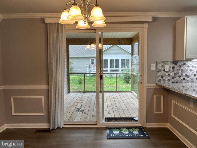 36697 W Club House Rd, Ocean View, DE 19970 - doorway with a chandelier, dark wood-type flooring, and crown molding