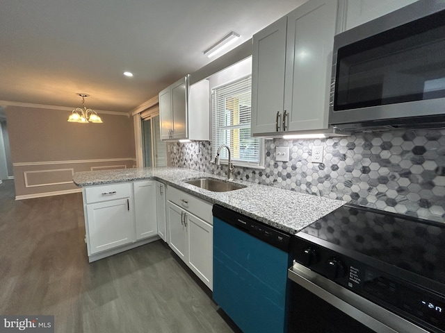 36697 W Club House Rd, Ocean View, DE 19970 - kitchen featuring appliances with stainless steel finishes, a chandelier, a peninsula, dark wood-type flooring, and backsplash