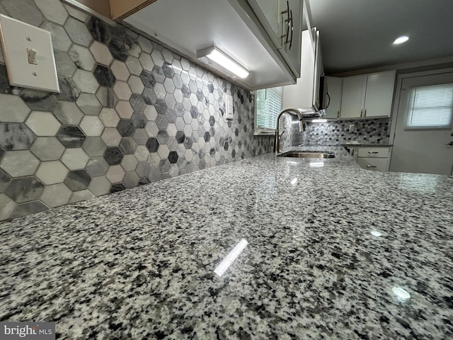 36697 W Club House Rd, Ocean View, DE 19970 - kitchen featuring light stone counters, decorative backsplash, white cabinetry, and recessed lighting
