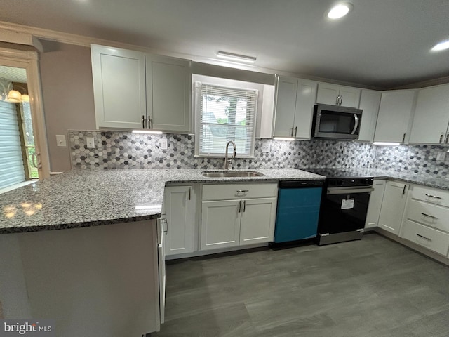 36697 W Club House Rd, Ocean View, DE 19970 - kitchen with stainless steel microwave, black range with electric stovetop, light stone countertops, dishwashing machine, and a peninsula