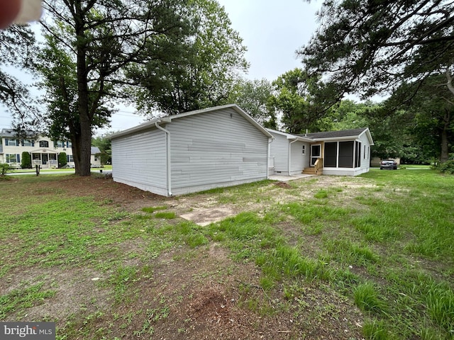 36697 W Club House Rd, Ocean View, DE 19970 - rear view of house featuring a sunroom, entry steps, and a lawn