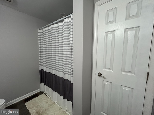 36697 W Club House Rd, Ocean View, DE 19970 - bathroom with curtained shower and wood finished floors