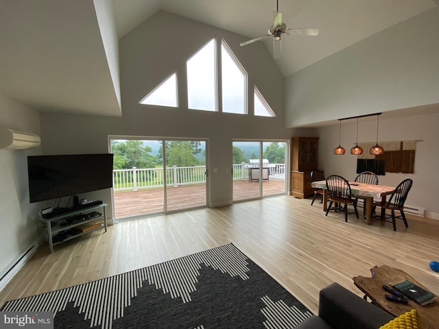 390 Summer Hill Rd, Schuylkill Haven, PA 17972 - living area featuring wood finished floors, a wall mounted AC, ceiling fan, and high vaulted ceiling