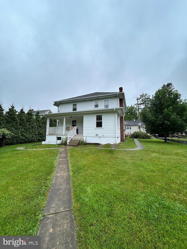 1989 Fair Rd, Schuylkill Haven, PA 17972 - view of front facade with a porch, a chimney, and a front yard