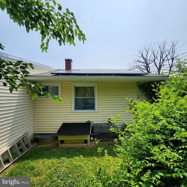 5508 Mayview Ave, Baltimore, MD 21206 - rear view of house with roof mounted solar panels and a chimney