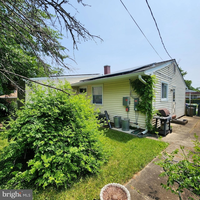 5508 Mayview Ave, Baltimore, MD 21206 - rear view of property with a chimney and a lawn