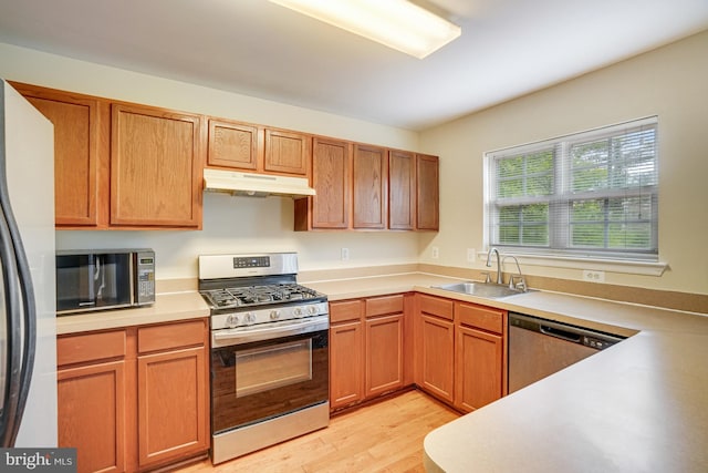 6187 Les Dorson Ln, Alexandria, VA 22315 - kitchen with appliances with stainless steel finishes, under cabinet range hood, light wood-type flooring, and light countertops