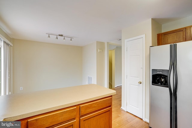 6187 Les Dorson Ln, Alexandria, VA 22315 - kitchen featuring stainless steel fridge with ice dispenser, light wood finished floors, light countertops, and brown cabinetry