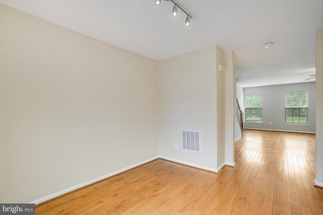 6187 Les Dorson Ln, Alexandria, VA 22315 - empty room featuring light wood finished floors, stairway, and rail lighting