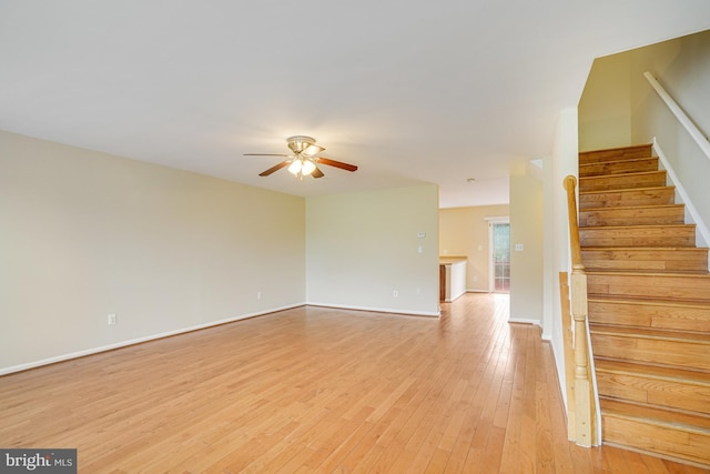 6187 Les Dorson Ln, Alexandria, VA 22315 - unfurnished living room featuring a ceiling fan, light wood-style flooring, and stairs