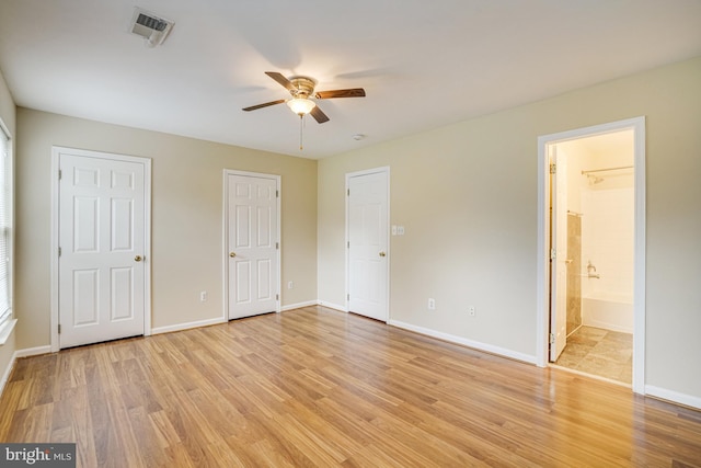 6187 Les Dorson Ln, Alexandria, VA 22315 - unfurnished bedroom with light wood-type flooring, connected bathroom, multiple closets, and a ceiling fan