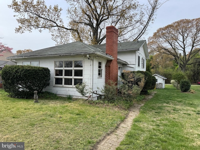 1930 Cedar Rd, Pasadena, MD 21122 - view of property exterior with a lawn, roof with shingles, and a chimney