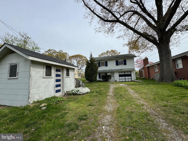 1930 Cedar Rd, Pasadena, MD 21122 - view of grassy yard with an outbuilding, an attached garage, and driveway