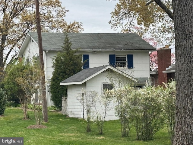 1930 Cedar Rd, Pasadena, MD 21122 - view of side of home with a shingled roof and a lawn