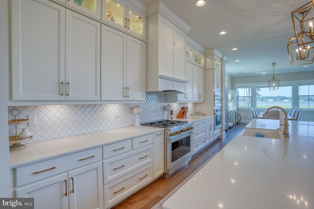 22261 Waterview Rd, Lewes, DE 19958 - kitchen with stainless steel appliances, wood finished floors, white cabinetry, light countertops, and recessed lighting