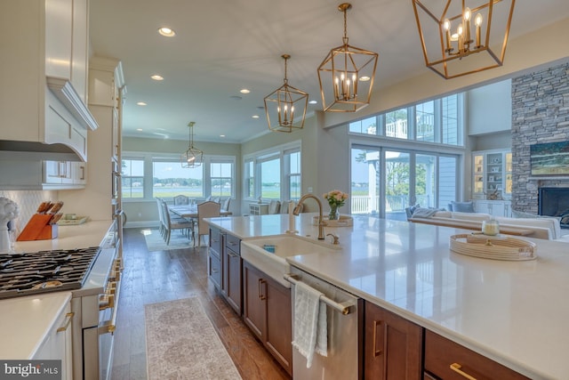 22261 Waterview Rd, Lewes, DE 19958 - kitchen with stainless steel dishwasher, open floor plan, a chandelier, wood finished floors, and recessed lighting