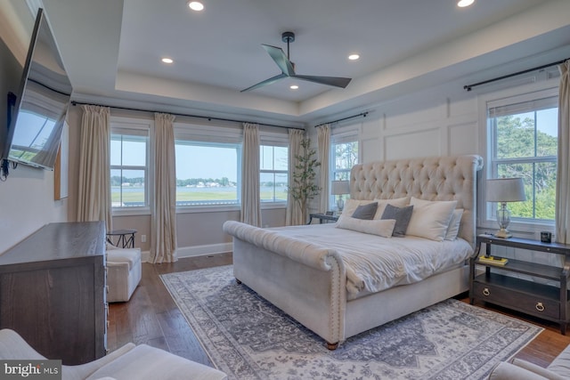 22261 Waterview Rd, Lewes, DE 19958 - bedroom with multiple windows, wood finished floors, recessed lighting, and a tray ceiling