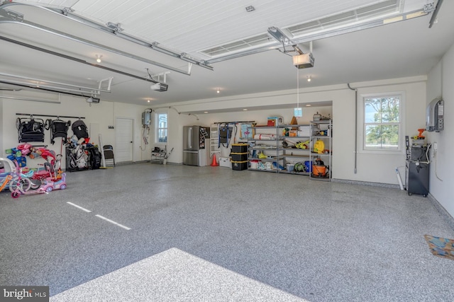 22261 Waterview Rd, Lewes, DE 19958 - garage with a garage door opener and freestanding refrigerator