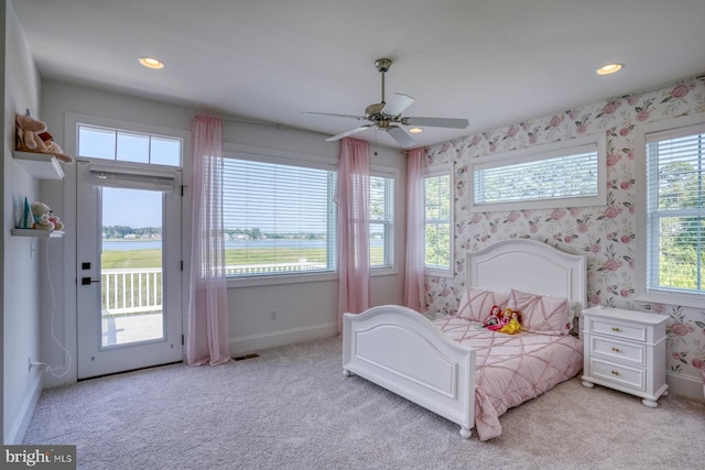 22261 Waterview Rd, Lewes, DE 19958 - bedroom with access to outside, light colored carpet, wallpapered walls, recessed lighting, and a water view
