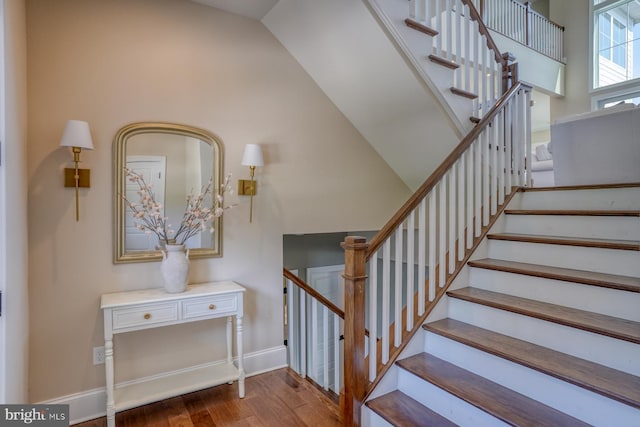 22261 Waterview Rd, Lewes, DE 19958 - stairway featuring wood finished floors and vaulted ceiling