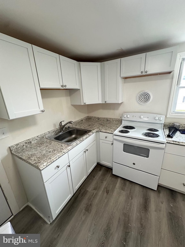 312 N 2nd St, Millville, NJ 08332 - kitchen with white electric range oven, dark wood-style floors, and white cabinetry