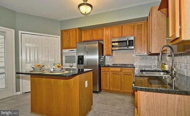 20 Harbour Heights Dr Unit 20, Annapolis, MD 21401 - kitchen featuring stainless steel appliances, decorative backsplash, and brown cabinetry