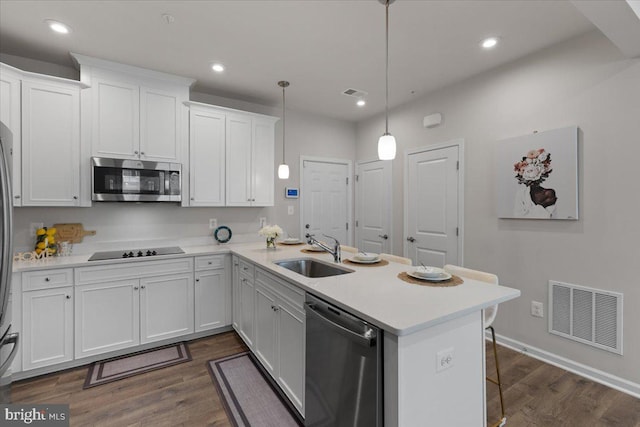 10544 Sally Ride Ln, Lanham, MD 20706 - kitchen with appliances with stainless steel finishes, a peninsula, white cabinetry, light countertops, and recessed lighting