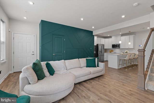 10544 Sally Ride Ln, Lanham, MD 20706 - living room with stairway, light wood finished floors, and recessed lighting