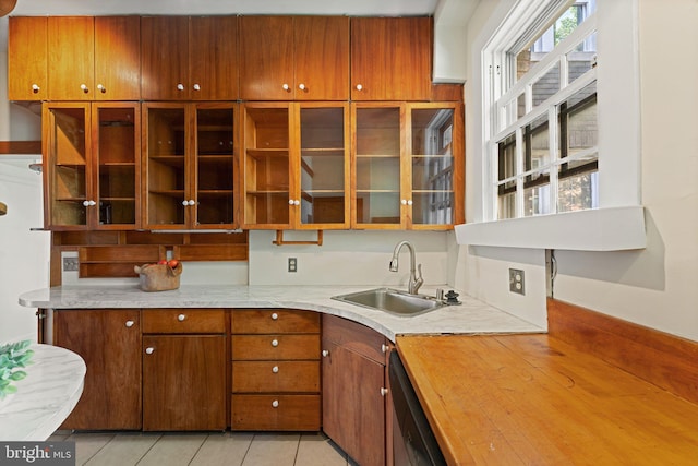 1623 Lanier Pl NW Unit 202, Washington, DC 20009 - kitchen featuring light countertops, dishwasher, light tile patterned floors, and glass insert cabinets