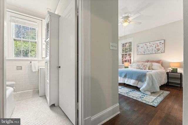 1623 Lanier Pl NW Unit 202, Washington, DC 20009 - bedroom with connected bathroom, light wood-style flooring, and tile walls