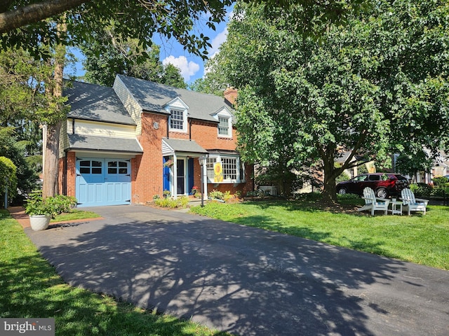 57 Chelfield Rd, Glenside, PA 19038 - view of front of property with brick siding, driveway, a front yard, and a chimney