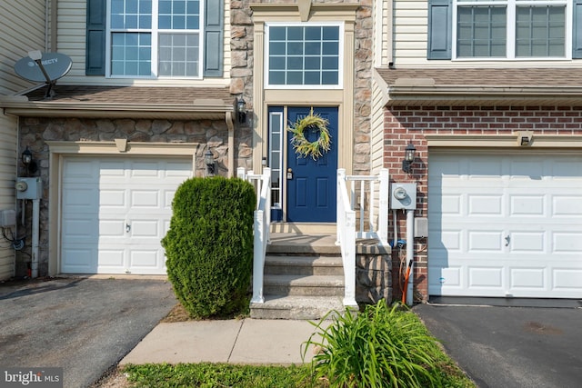 325 Cape Climb, York, PA 17408 - view of exterior entry featuring an attached garage, asphalt driveway, roof with shingles, and brick siding