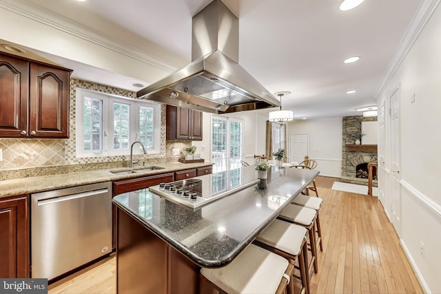 6536 Little Ox Rd, Fairfax Station, VA 22039 - kitchen with island exhaust hood, appliances with stainless steel finishes, decorative backsplash, ornamental molding, and a kitchen breakfast bar