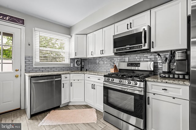 202 Cranford Rd, Cherry Hill, NJ 08003 - kitchen featuring appliances with stainless steel finishes, white cabinets, light stone counters, and decorative backsplash