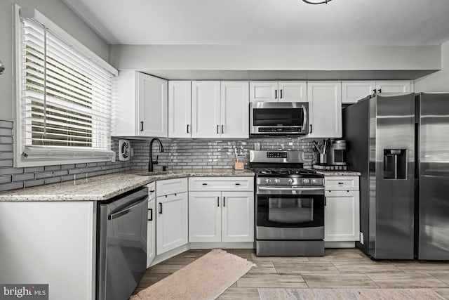 202 Cranford Rd, Cherry Hill, NJ 08003 - kitchen featuring stainless steel appliances, white cabinetry, tasteful backsplash, and light stone counters
