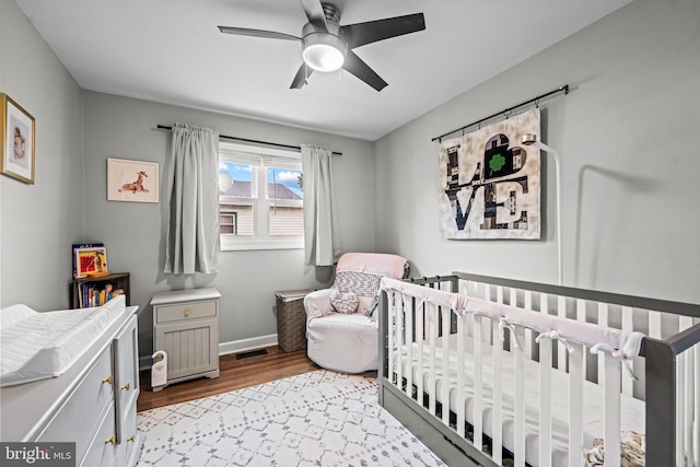 202 Cranford Rd, Cherry Hill, NJ 08003 - bedroom featuring wood finished floors, a nursery area, and a ceiling fan